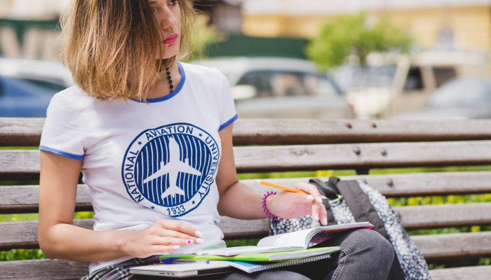 Young woman weared in a merchandise t-shirt of a university